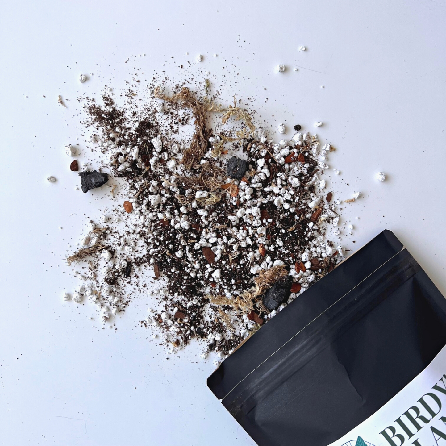 A bag of Birdy's Plants 2L Premium Alocasia Soil Mix being spilled out .