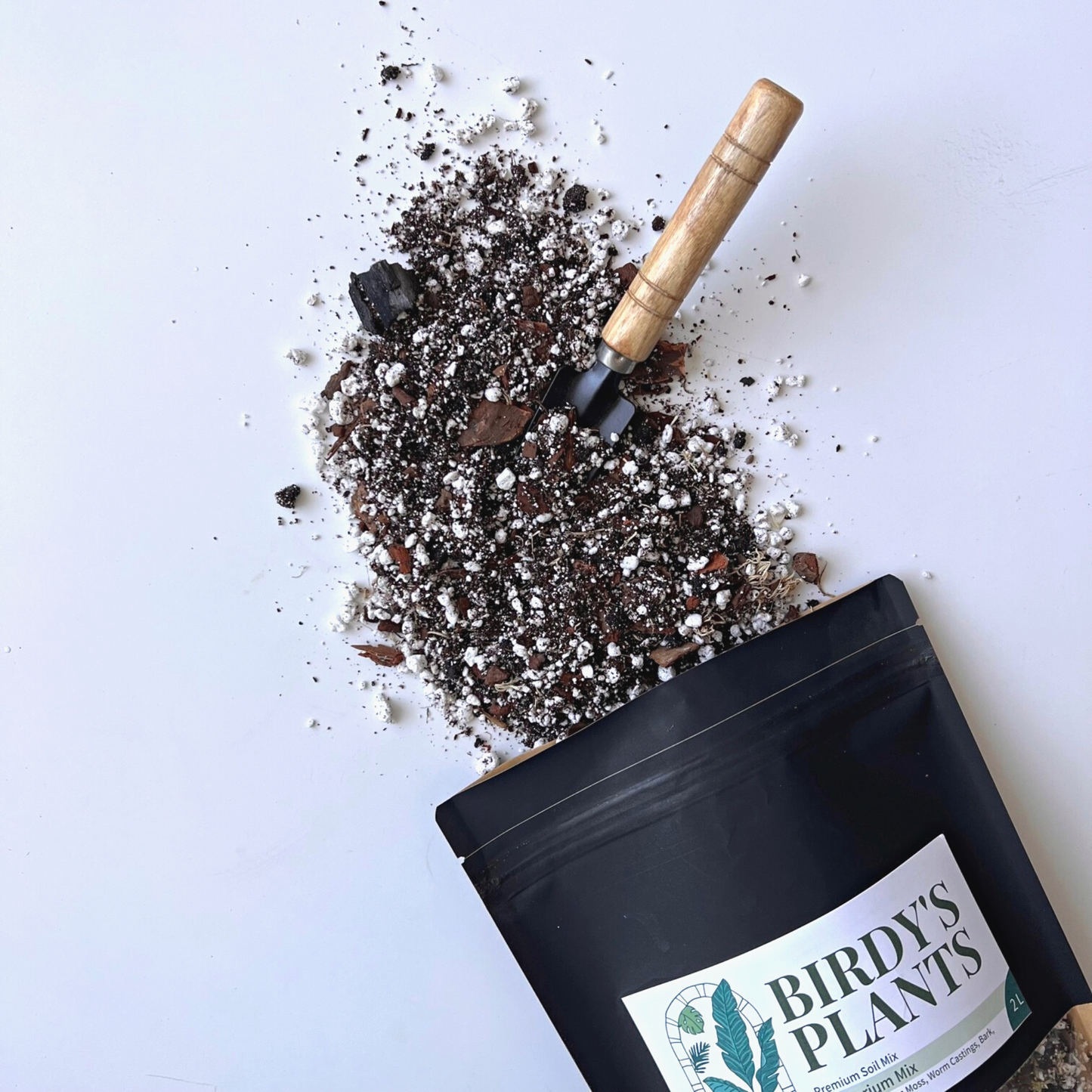 A bag of Birdy's Plants 2L Premium Anthurium Soil Mix being spilled out .