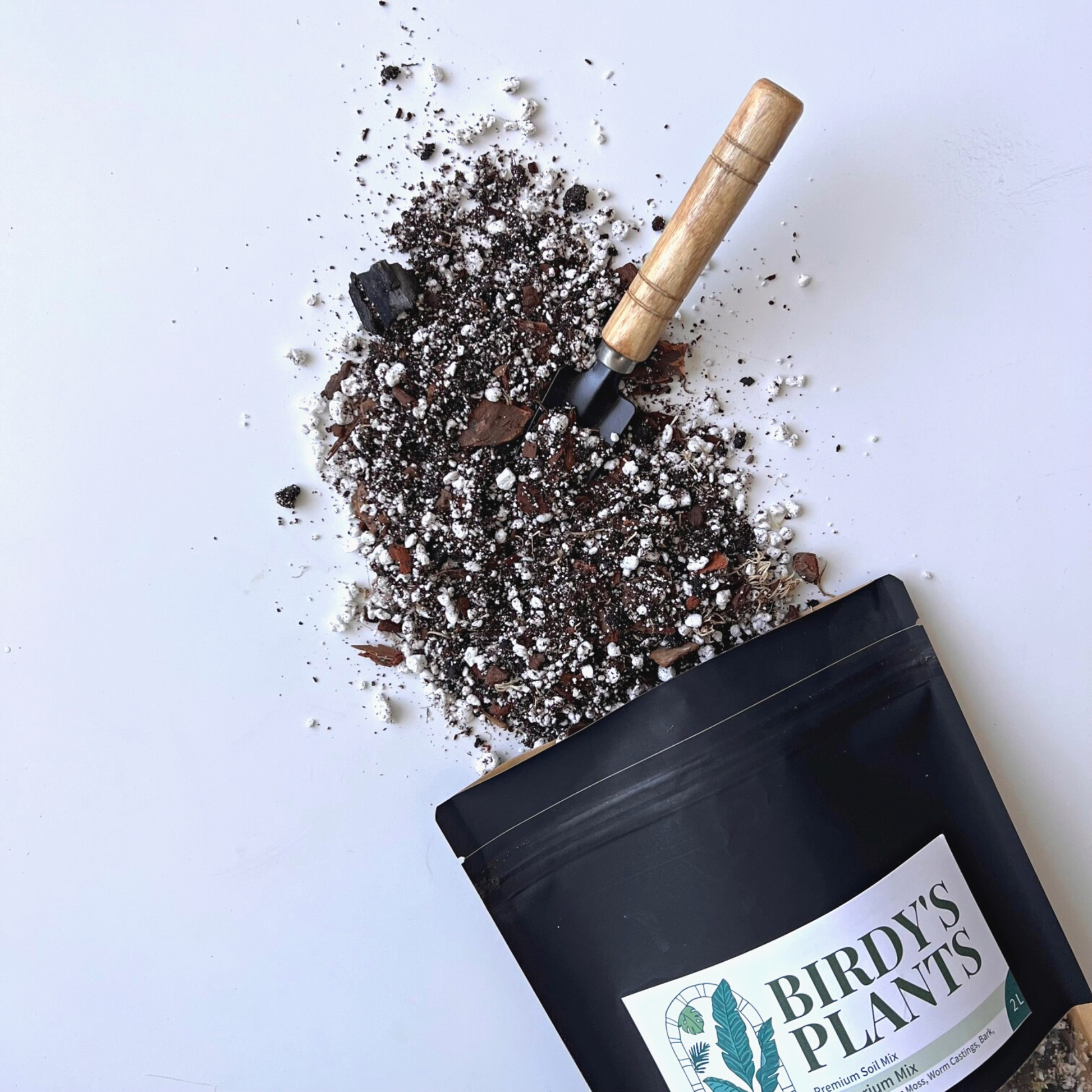A bag of Birdy's Plants 2L Premium Anthurium Soil Mix being spilled out .