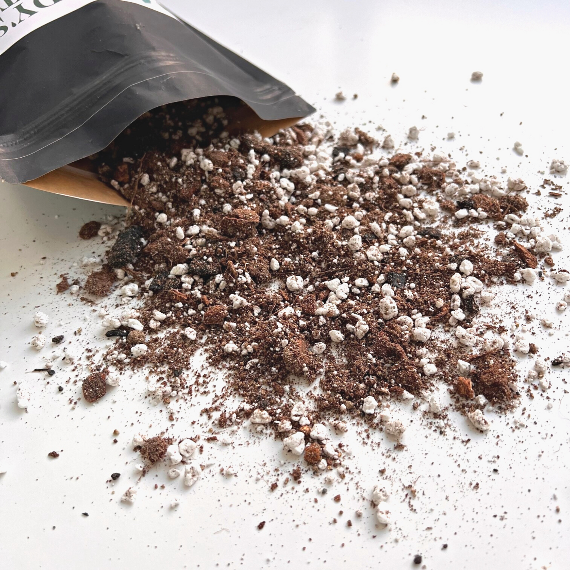A bag of Birdy's Plants 2L Premium Ficus Soil Mix being spilled out .
