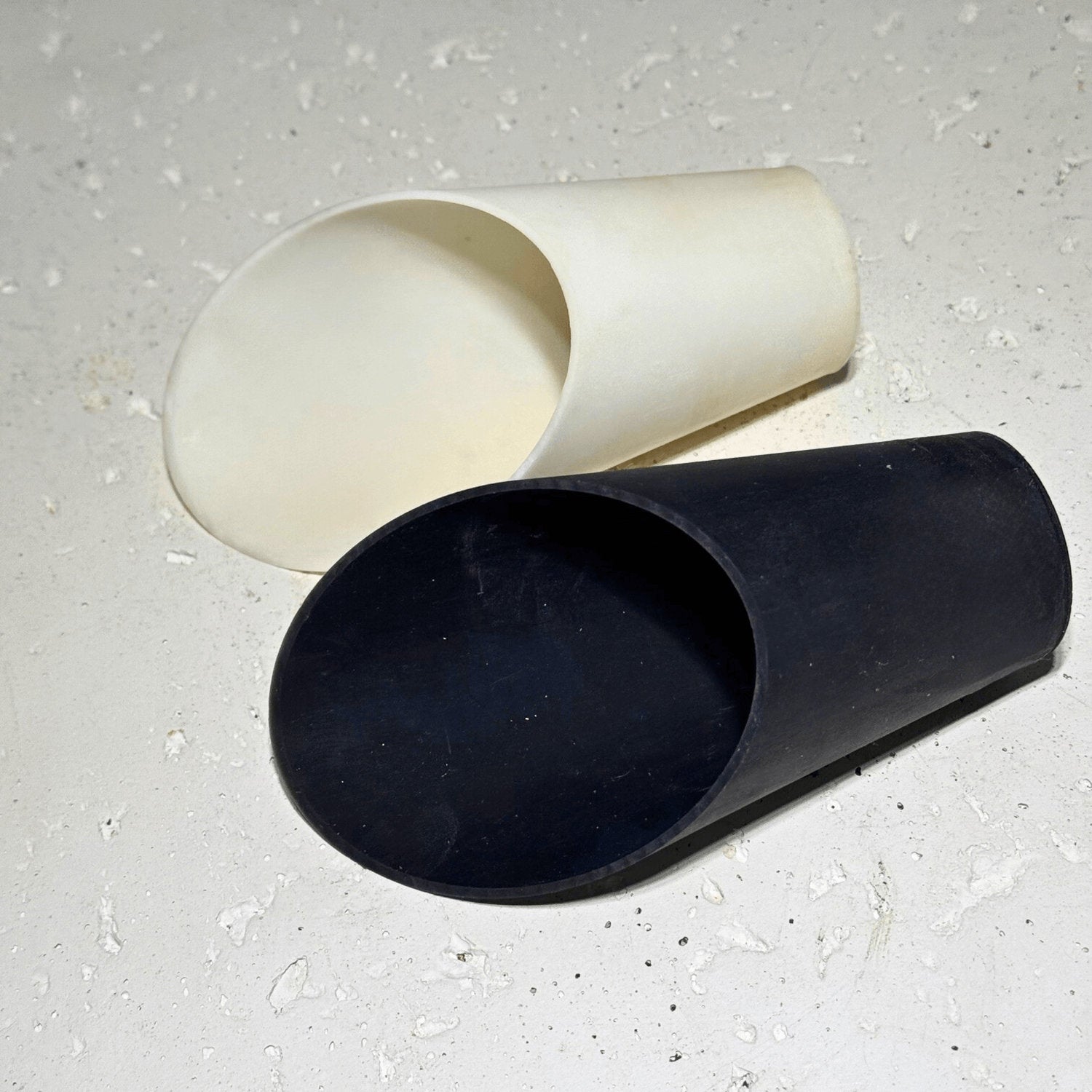 Black and white soil scoops on neutral background, indoor plant tools for precise soil transfer and repotting